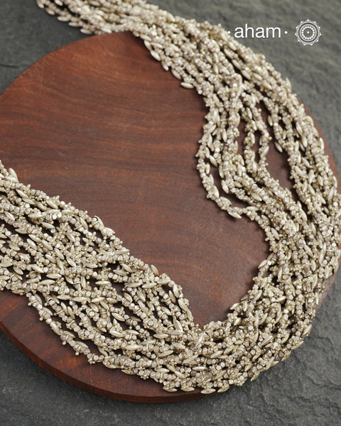 The Odhisa Dhaan Sarson Mala is a masterful vintage creation that embodies both heritage and symbolism.

Featuring multiple strands of delicately crafted rice- (Dhaan) and mustard- (Sarson) shaped silver beads, this neckpiece reflects the cultural traditions of the Kutia Kondh tribals of Odisha, for whom these forms represent prosperity, fertility, and abundance.