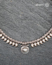 Rooted in the living traditions of Odisha’s tribe, this rare Odhia neckpiece is a celebration of tribal artistry preserved through generations. Crafted in authentic silver and traditionally strung on cotton thread, each bead is meticulously hand-worked using age-old techniques passed down by master artisans.

See the detailing of every element. The beautiful ambi shaped beads in two different sizes and the intricately details beads, all crafted in high grade silve.&nbsp; &nbsp;Every element of the neckpiece