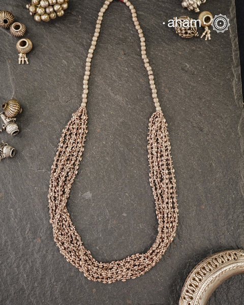 The Odhisa Dhaan Sarson Mala is a masterful vintage creation that embodies both heritage and symbolism.

Featuring multiple strands of delicately crafted rice- (Dhaan) and mustard- (Sarson) shaped silver beads, this neckpiece reflects the cultural traditions of the Kutia Kondh tribals of Odisha, for whom these forms represent prosperity, fertility, and abundance.

