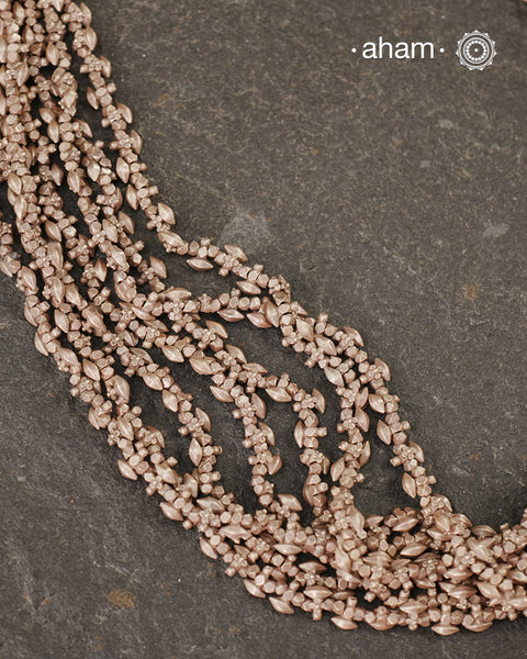 The Odhisa Dhaan Sarson Mala is a masterful vintage creation that embodies both heritage and symbolism.

Featuring multiple strands of delicately crafted rice- (Dhaan) and mustard- (Sarson) shaped silver beads, this neckpiece reflects the cultural traditions of the Kutia Kondh tribals of Odisha, for whom these forms represent prosperity, fertility, and abundance.
