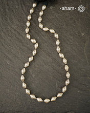 Silver Dholki/ Wax Beads coated with silver foil with black adjustable thread. Also known as Bor Mala