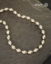 Silver Dholki/ Wax Beads coated with silver foil with black adjustable thread. Also known as Bor Mala