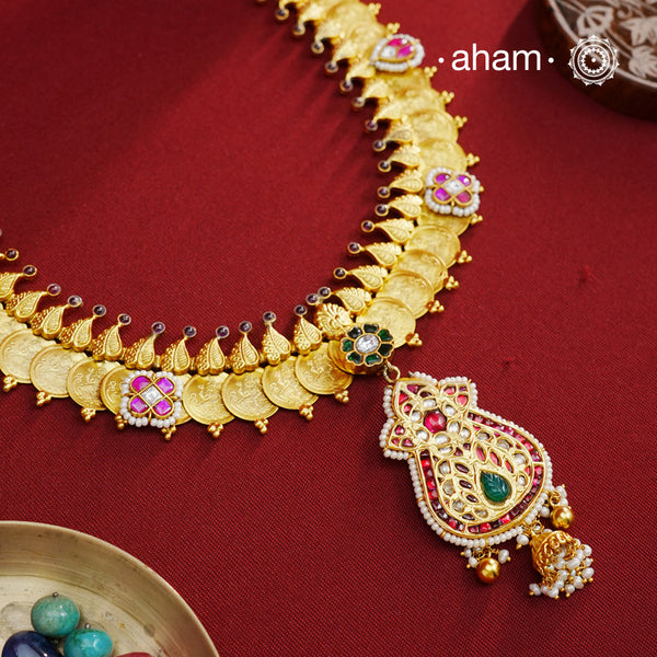 The classic kasu mala - coin neckpiece that never goes out of style. Crafted in 92.5 silver with gold polish. Exquisitely elegant, the heritage collection features traditional motifs and intricate workmanship on gold-plated silver jewellery, a reflection of the rich culture of India. This collection is perfect for brides and bridesmaids. Kasu Mala is a&nbsp;popular, traditional south Indian neckpiece. The word 'Kasu' means coin, and 'Mala' denotes necklace. 