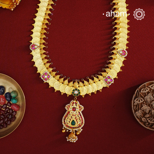The classic kasu mala - coin neckpiece that never goes out of style. Crafted in 92.5 silver with gold polish. Exquisitely elegant, the heritage collection features traditional motifs and intricate workmanship on gold-plated silver jewellery, a reflection of the rich culture of India. This collection is perfect for brides and bridesmaids. Kasu Mala is a popular, traditional south Indian neckpiece. The word 'Kasu' means coin, and 'Mala' denotes necklace. 