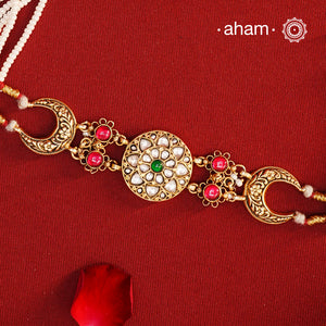 This Kundan Gold Polish Silver neckpiece is perfect for those who love wearing chokers. The center piece is made with Kundan, while the pearl strings add a touch of elegance. Crafted in 92.5 silver, it's a beautiful and timeless addition to any outfit.