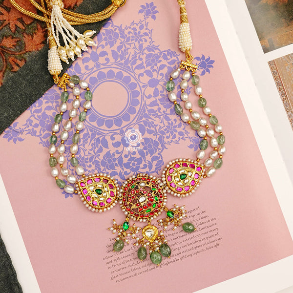 Make a sophisticated style statement with this gold polish festive choker with an elegant swan motif. Handcrafted in 92.5 sterling silver with rani pink kundan work, green semi precious beads and cultured pearls. Perfect for intimate weddings and upcoming festive celebrations.  