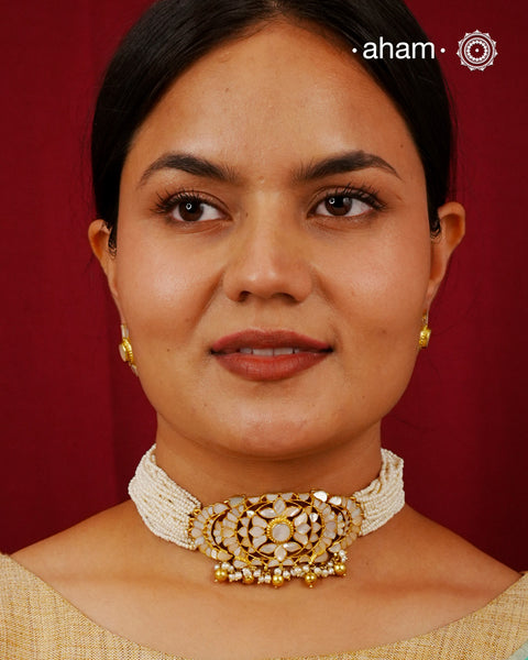 Embrace the allure of timeless elegance with Aham Jewellery’s latest Mother of Pearl collection, a radiant choice for festive celebrations and weddings.

The choker is crafted in 92.5 silver and adorned with a luxurious gold polish, capturing the iridescent beauty of mother of pearl.