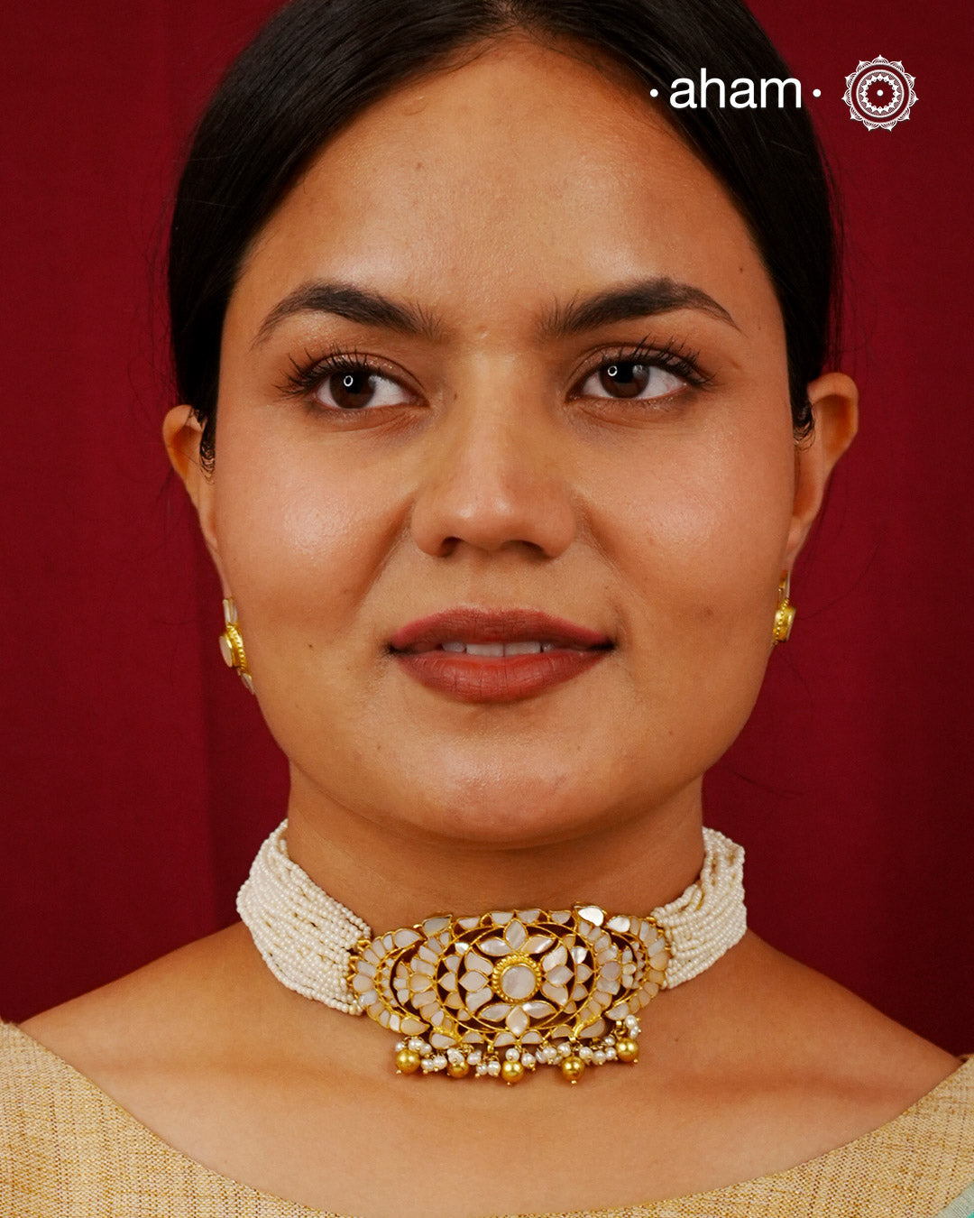Embrace the allure of timeless elegance with Aham Jewellery’s latest Mother of Pearl collection, a radiant choice for festive celebrations and weddings.

The choker is crafted in 92.5 silver and adorned with a luxurious gold polish, capturing the iridescent beauty of mother of pearl.