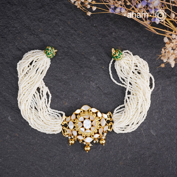 Embrace the allure of timeless elegance with Aham Jewellery’s latest Mother of Pearl collection, a radiant choice for festive celebrations and weddings.

The Neckpiece is crafted in 92.5 silver and adorned with a luxurious gold polish, capturing the iridescent beauty of mother of pearl. You can wear this versatile piece like a choker or a around the neck piece.