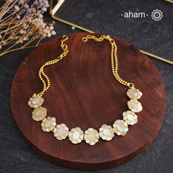 Embrace the allure of timeless elegance with Aham Jewellery’s latest Mother of Pearl collection, a radiant choice for festive celebrations and weddings.

The Neckpiece is crafted in 92.5 silver and adorned with a luxurious gold polish, capturing the iridescent beauty of mother of pearl. You can wear this versatile piece like a choker or a around the neck piece and even as a mathapati.