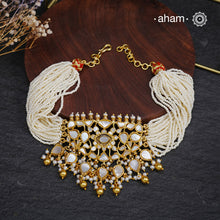 Embrace the allure of timeless elegance with Aham Jewellery’s latest Mother of Pearl collection, a radiant choice for festive celebrations and weddings.

The choker is crafted in 92.5 silver and adorned with a luxurious gold polish, capturing the iridescent beauty of mother of pearl. You can wear this versatile piece like a choker or a around the neck piece.