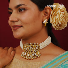 Embrace the allure of timeless elegance with Aham Jewellery’s latest Mother of Pearl collection, a radiant choice for festive celebrations and weddings.

The choker is crafted in 92.5 silver and adorned with a luxurious gold polish, capturing the iridescent beauty of mother of pearl. You can wear this versatile piece like a choker or a around the neck piece.