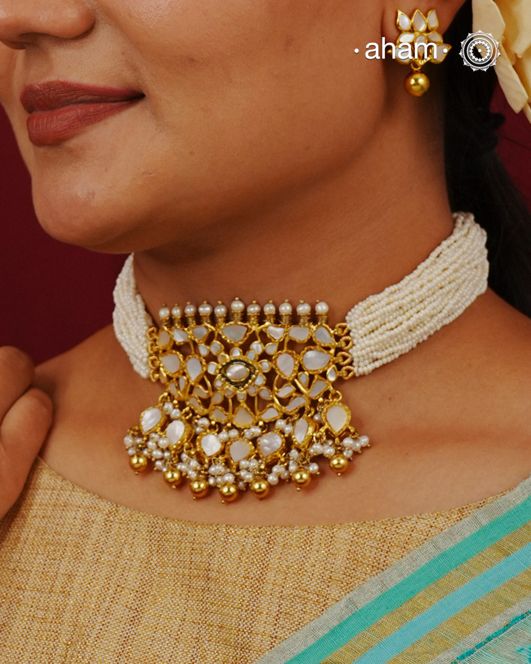 Embrace the allure of timeless elegance with Aham Jewellery’s latest Mother of Pearl collection, a radiant choice for festive celebrations and weddings.

The choker is crafted in 92.5 silver and adorned with a luxurious gold polish, capturing the iridescent beauty of mother of pearl. You can wear this versatile piece like a choker or a around the neck piece.