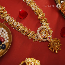 Expertly crafted in silver with intricate kundan and pearl work, this elegant Gold Polish Silver Neckpiece is the perfect addition to your wedding or family occasion attire. Its stunning design exudes sophistication and will surely make you stand out from the crowd. Make a statement with this exquisite neckpiece.