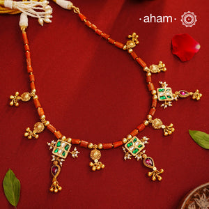 Experience timeless elegance with our Gold Polish Silver Neckpiece. Crafted with raw coral beads and intricate kundan tukdis, this short neckpiece exudes subtle charm. Its traditional design crafted in silver and shining gold polish make it a beautiful addition to any jewellery lovers collection. Indulge in eternal style with our everygreen neckpiece.