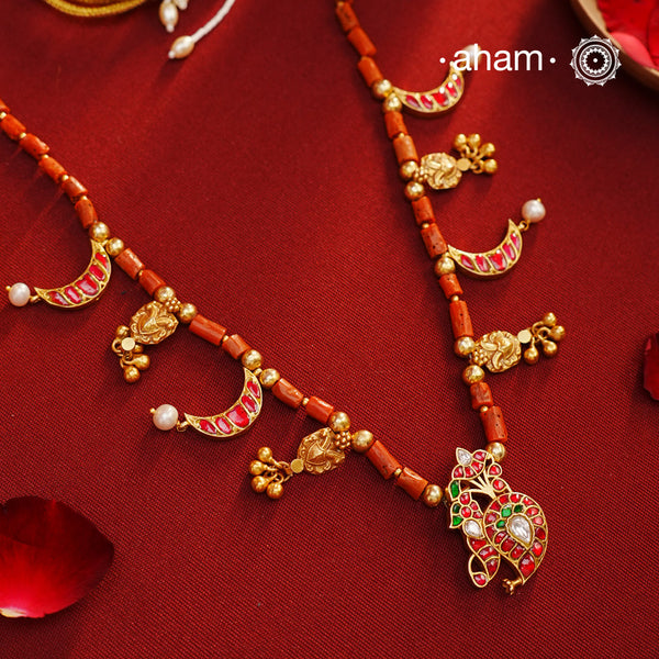Experience timeless elegance with our Gold Polish Silver Neckpiece. Crafted with raw coral beads and intricate kundan tukdis, this short neckpiece exudes subtle charm. Its traditional design crafted in silver and shining gold polish make it a beautiful addition to any jewellery lovers collection. Indulge in eternal style with our everygreen neckpiece.