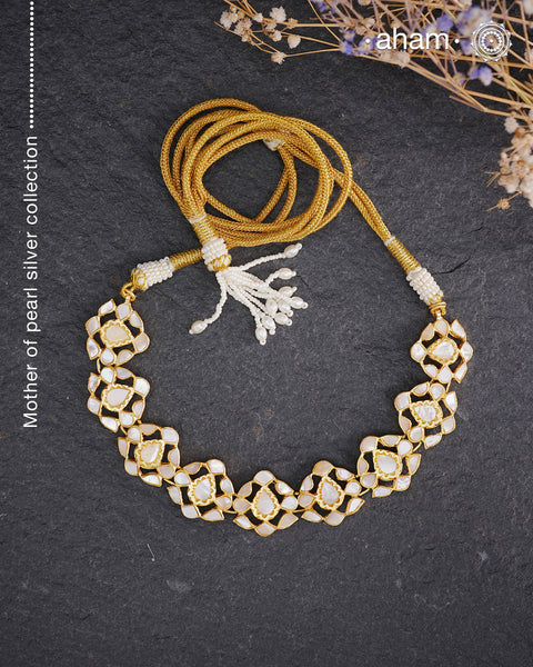 Embrace the allure of timeless elegance with Aham Jewellery’s latest Mother of Pearl collection, a radiant choice for festive celebrations and weddings.
The neckpiece is crafted in 92.5 silver and adorned with a luxurious gold polish, capturing the iridescent beauty of mother of pearl. You can wear this versatile piece like a choker or below the neck and even as a mathapati.
