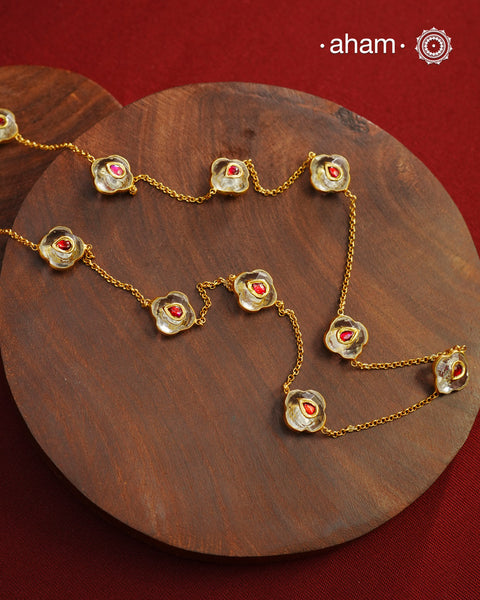 This handcrafted silver neckpiece features exquisite clear quartz and intricate kundan inlay work, enhanced with a refined gold polish. Designed for versatility, it can be worn as a single long line or doubled for a layered look, making it a sophisticated addition to any jewellery collection.