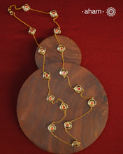 This handcrafted silver neckpiece features exquisite clear quartz and intricate kundan inlay work, enhanced with a refined gold polish. Designed for versatility, it can be worn as a single long line or doubled for a layered look, making it a sophisticated addition to any jewellery collection.