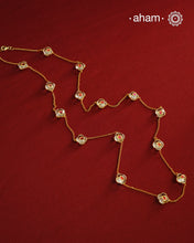 This handcrafted silver neckpiece features exquisite clear quartz and intricate kundan inlay work, enhanced with a refined gold polish. Designed for versatility, it can be worn as a single long line or doubled for a layered look, making it a sophisticated addition to any jewellery collection.