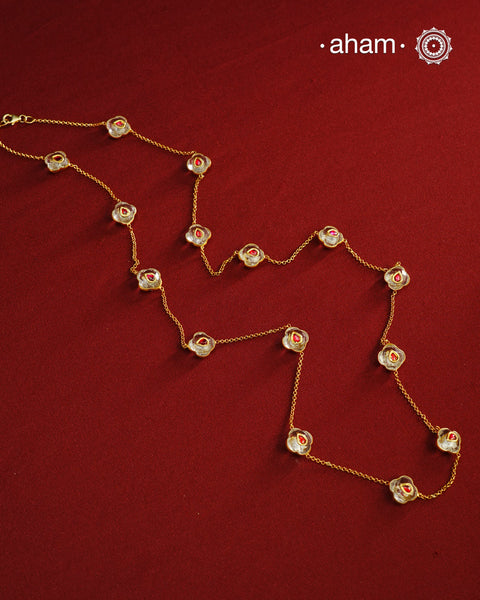 This handcrafted silver neckpiece features exquisite clear quartz and intricate kundan inlay work, enhanced with a refined gold polish. Designed for versatility, it can be worn as a single long line or doubled for a layered look, making it a sophisticated addition to any jewellery collection.