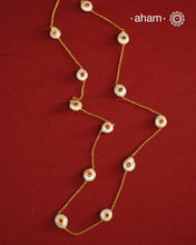 This handcrafted silver neckpiece features exquisite mother of pearl and intricate kundan inlay work, enhanced with a refined gold polish. Designed for versatility, it can be worn as a single long line or doubled for a layered look, making it a sophisticated addition to any jewellery collection.