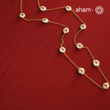This handcrafted silver neckpiece features exquisite mother of pearl and intricate kundan inlay work, enhanced with a refined gold polish. Designed for versatility, it can be worn as a single long line or doubled for a layered look, making it a sophisticated addition to any jewellery collection.