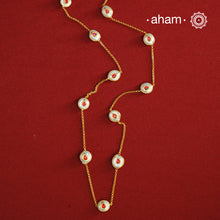This handcrafted silver neckpiece features exquisite mother of pearl and intricate kundan inlay work, enhanced with a refined gold polish. Designed for versatility, it can be worn as a single long line or doubled for a layered look, making it a sophisticated addition to any jewellery collection.