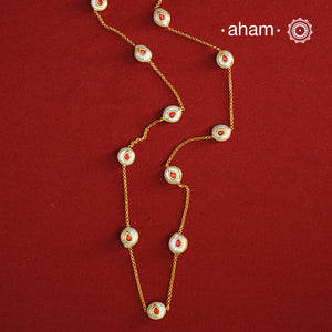 This handcrafted silver neckpiece features exquisite mother of pearl and intricate kundan inlay work, enhanced with a refined gold polish. Designed for versatility, it can be worn as a single long line or doubled for a layered look, making it a sophisticated addition to any jewellery collection.