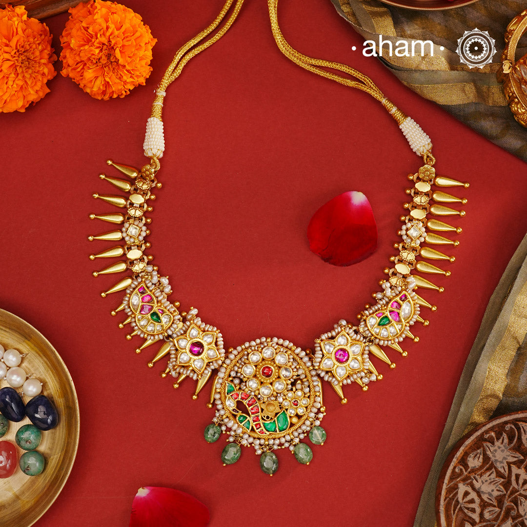 Expertly crafted for your special days, the Kundan Gold Polish Silver Neckpiece is a timeless addition to your wedding ensemble. Made with 92.5 silver and adorned with intricate kundan and pearl work, this neckpiece adds a touch of elegance to any outfit. Elevate your style with this exquisite piece.