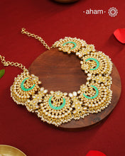 Elevate your festive look with this exquisite Pearl &amp; Turquoise Gold Polish Silver Neckpiece. Crafted in 92.5% silver with a delicate gold polish, its chand-shaped design beautifully blends vibrant turquoise and lustrous pearls. Ideal for mehandi, haldi ceremonies, or a friend’s wedding, this piece adds a touch of elegance and tradition to your ensemble. Make every celebration memorable with this stunning accessory.