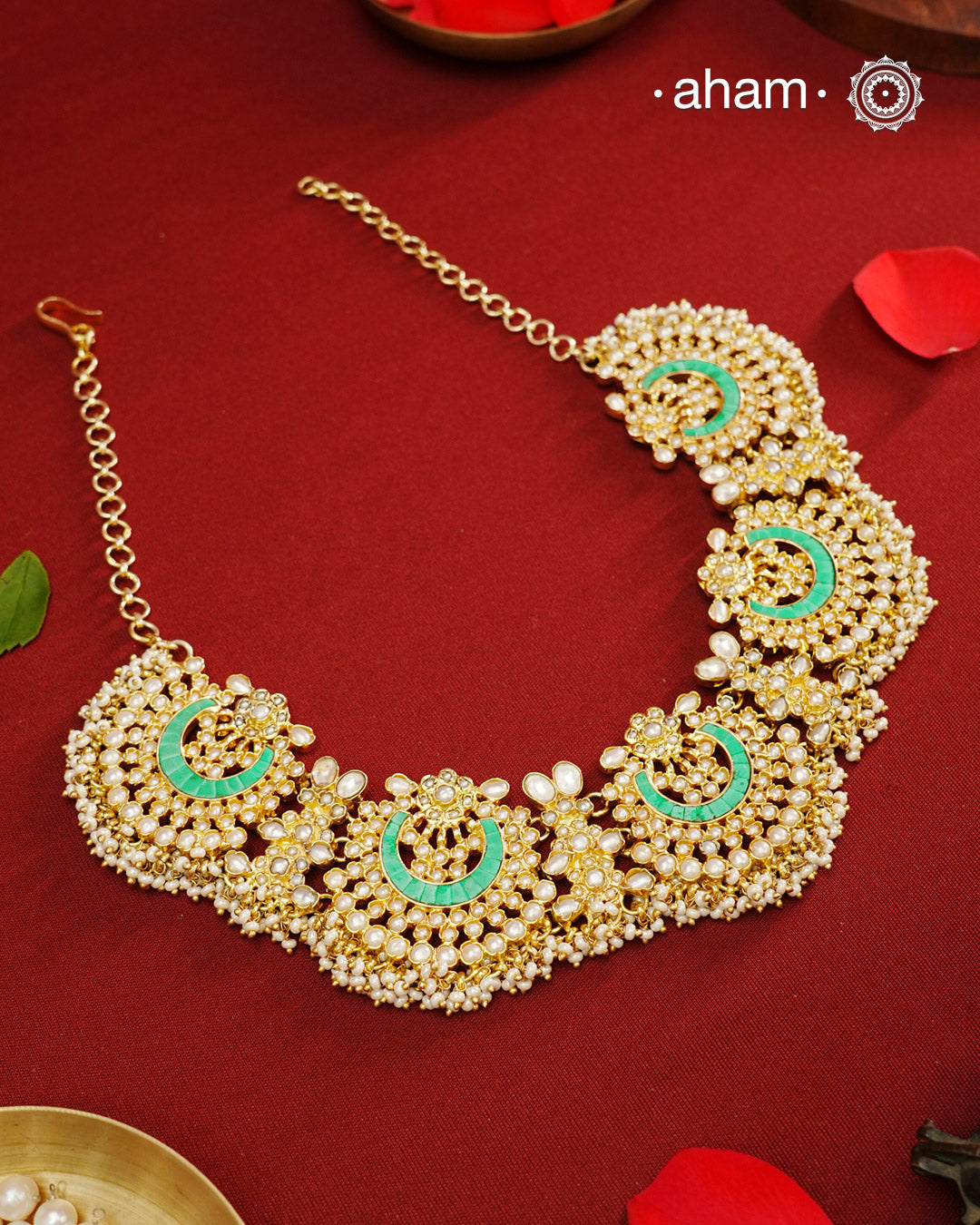 Elevate your festive look with this exquisite Pearl & Turquoise Gold Polish Silver Neckpiece. Crafted in 92.5% silver with a delicate gold polish, its chand-shaped design beautifully blends vibrant turquoise and lustrous pearls. Ideal for mehandi, haldi ceremonies, or a friend’s wedding, this piece adds a touch of elegance and tradition to your ensemble. Make every celebration memorable with this stunning accessory.