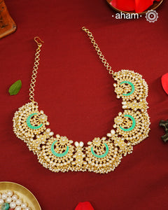 Elevate your festive look with this exquisite Pearl &amp; Turquoise Gold Polish Silver Neckpiece. Crafted in 92.5% silver with a delicate gold polish, its chand-shaped design beautifully blends vibrant turquoise and lustrous pearls. Ideal for mehandi, haldi ceremonies, or a friend’s wedding, this piece adds a touch of elegance and tradition to your ensemble. Make every celebration memorable with this stunning accessory.