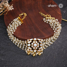 Embrace the allure of timeless elegance with Aham Jewellery’s latest Mother of Pearl collection, a radiant choice for festive celebrations and weddings.

The choker is crafted in 92.5 silver and adorned with a luxurious gold polish, capturing the iridescent beauty of mother of pearl.