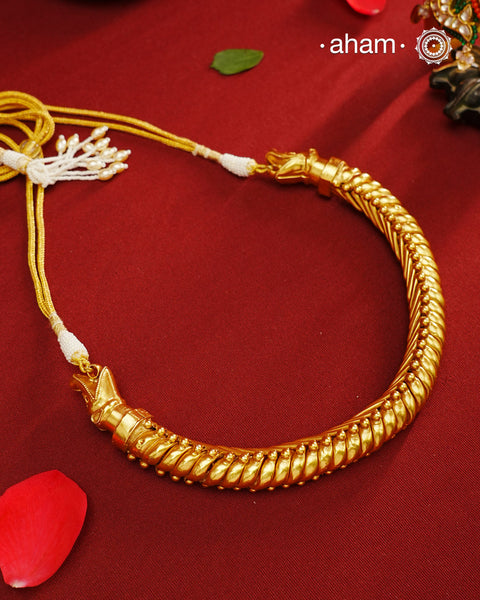 This elegant Sutlada silver neckpiece with gold polish is the epitome of timeless style. Crafted with traditional techniques, it exudes sophistication and class. Perfect for any occasion, this neckpiece is a must-have for those who appreciate timeless beauty.