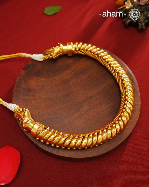 This elegant Sutlada silver neckpiece with gold polish is the epitome of timeless style. Crafted with traditional techniques, it exudes sophistication and class. Perfect for any occasion, this neckpiece is a must-have for those who appreciate timeless beauty.