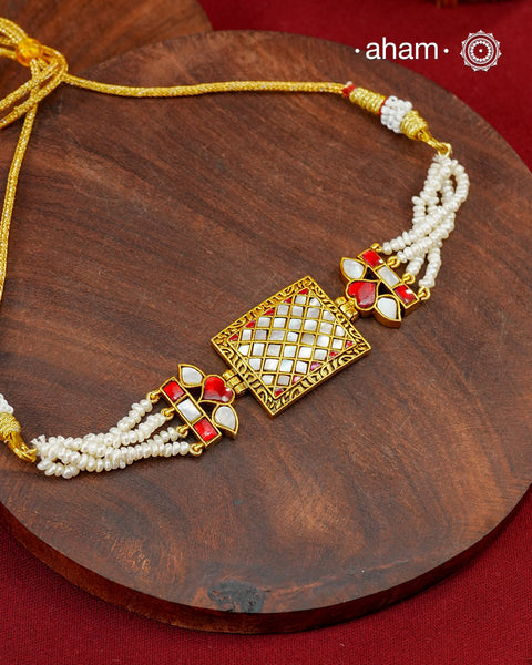 Delicate choker crafted in 92.5 silver with gold polish, detailed with kundan and mother of pearl work in the center along with fresh water pearls. Perfect for intimate celebrations.