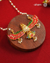 Eagle in flight crafted in 92.5 silver with kundan work and gold polish. Laced with delicate pearls and a pearl chain.