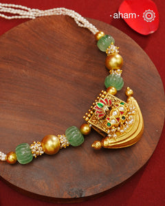 Elevate your style with our Gold Polish Amulet Silver Neckpiece. Crafted in silver and dipped in lustrous gold polish, this beautiful neckpiece features amulet with kundan work and semi-precious stones mala. Make an elegant statement with this stunning accessory.