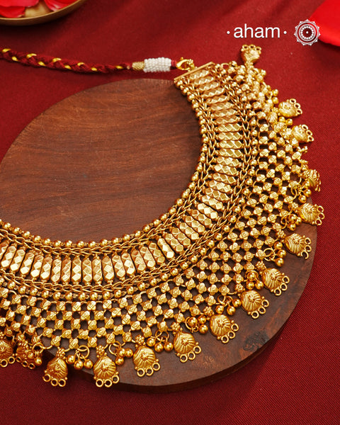 This stunning neckpiece is meticulously crafted from silver and finished with a rich gold polish, designed to gracefully cover the entire neckline. Showcasing intricate craftsmanship, it reflects expert artistry and attention to detail, making it a sophisticated statement piece for refined tastes.