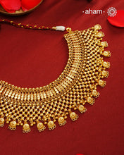 This stunning neckpiece is meticulously crafted from silver and finished with a rich gold polish, designed to gracefully cover the entire neckline. Showcasing intricate craftsmanship, it reflects expert artistry and attention to detail, making it a sophisticated statement piece for refined tastes.