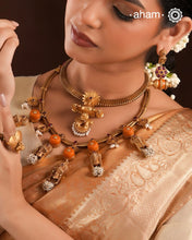 Traditional south Indian Jewellery motifs reimagined in a contemporary form along with coral and pearls. Crafted in 92.5 silver and dipped in beautiful gold polish.