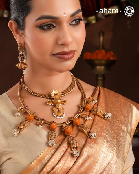Traditional south Indian Jewellery motifs reimagined in a contemporary form along with coral and pearls. Crafted in 92.5 silver and dipped in beautiful gold polish.