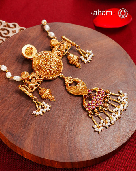 Inspired by the intricate designs of South temple art, this neckpiece is expertly crafted from 92.5% pure silver and finished with a refined dull gold polish. Complemented by a delicate pearl chain, it embodies a harmonious blend of traditional craftsmanship and timeless elegance, ideal for enhancing any special occasion ensemble.