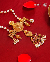 Inspired by the intricate designs of South temple art, this neckpiece is expertly crafted from 92.5% pure silver and finished with a refined dull gold polish. Complemented by a delicate pearl chain, it embodies a harmonious blend of traditional craftsmanship and timeless elegance, ideal for enhancing any special occasion ensemble.
