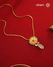Beautiful blooming lotus pendant with delicate pearls, this neckpiece is expertly crafted from 92.5% pure silver and finished with fine dull gold polish. Complemented by a delicate chain, it embodies a harmonious blend of traditional craftsmanship and timeless elegance, ideal for enhancing any special occasion ensemble.