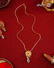 Beautiful blooming lotus pendant with delicate pearls, this neckpiece is expertly crafted from 92.5% pure silver and finished with fine dull gold polish. Complemented by a delicate chain, it embodies a harmonious blend of traditional craftsmanship and timeless elegance, ideal for enhancing any special occasion ensemble.