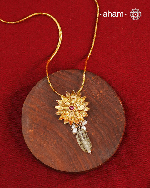 Beautiful blooming lotus pendant with delicate pearls, this neckpiece is expertly crafted from 92.5% pure silver and finished with fine dull gold polish. Complemented by a delicate chain, it embodies a harmonious blend of traditional craftsmanship and timeless elegance, ideal for enhancing any special occasion ensemble.