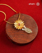 Beautiful blooming lotus pendant with delicate pearls, this neckpiece is expertly crafted from 92.5% pure silver and finished with fine dull gold polish. Complemented by a delicate chain, it embodies a harmonious blend of traditional craftsmanship and timeless elegance, ideal for enhancing any special occasion ensemble.