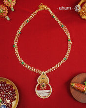 Inspired by the intricate designs of South temple art, this neckpiece is expertly crafted from 92.5% pure silver and finished with a refined dull gold polish. Complemented by a delicate pearl chain, it embodies a harmonious blend of traditional craftsmanship and timeless elegance, ideal for enhancing any special occasion ensemble.